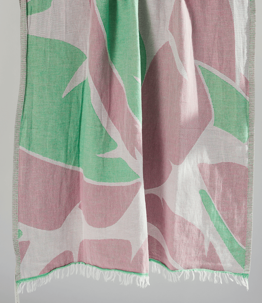 Turkish Beach Towel featuring a vibrant leaf pattern in greens and pinks