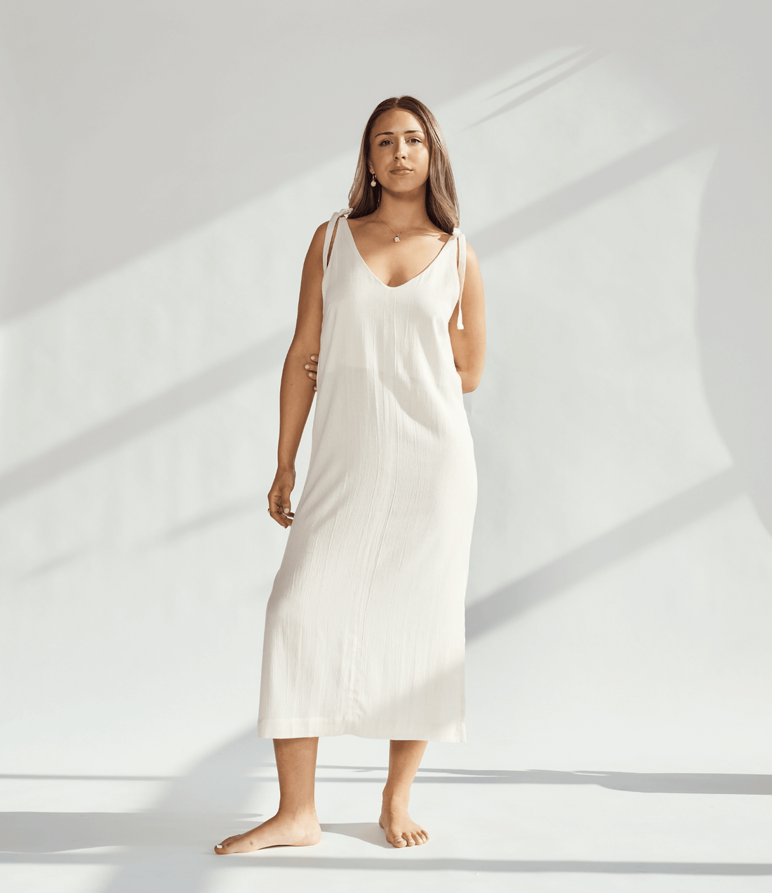 Soft cotton dress with tied straps, showcasing elegant design and breathable fabric for comfortable wear.