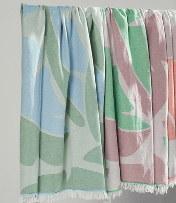Pastel coloured Turkish Beach Towels featuring leaf patterns in blue, green, and pink