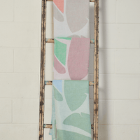Pastel Coloured Turkish Beach Towels showcasing leaf patterns hanging on a rustic ladder.