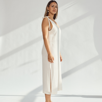 Elegant soft cotton dress with tied straps and leg slits, showcasing breathable style and comfort.