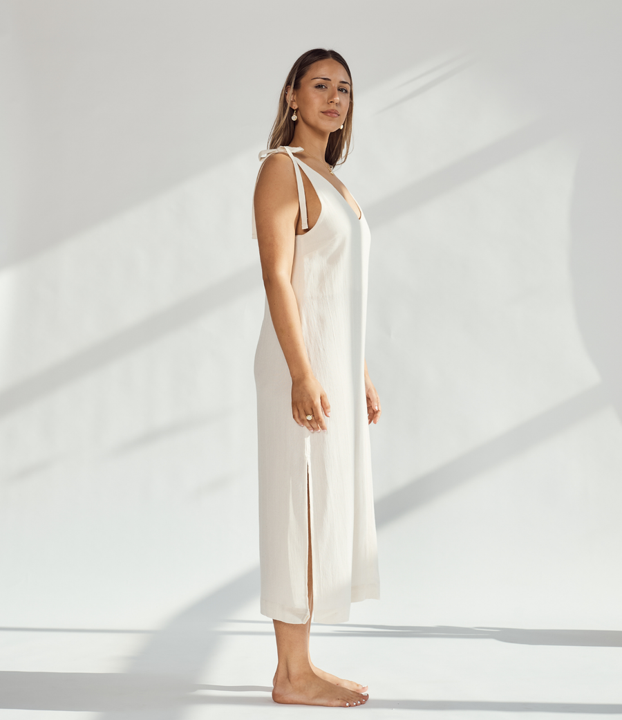 Elegant soft cotton dress with tied straps and leg slits, showcasing breathable style and comfort.