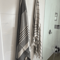 Two premium linen "Kekova" Turkish towel hanging on bathroom wall