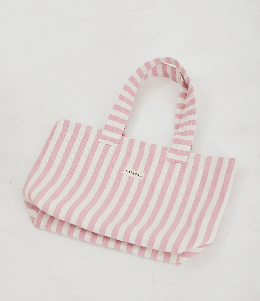 Herringbone woven linen tote bag in Light Pink layed flat on floor 