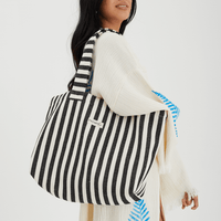 Herringbone woven linen tote bag in Black stripe worn over shoulder