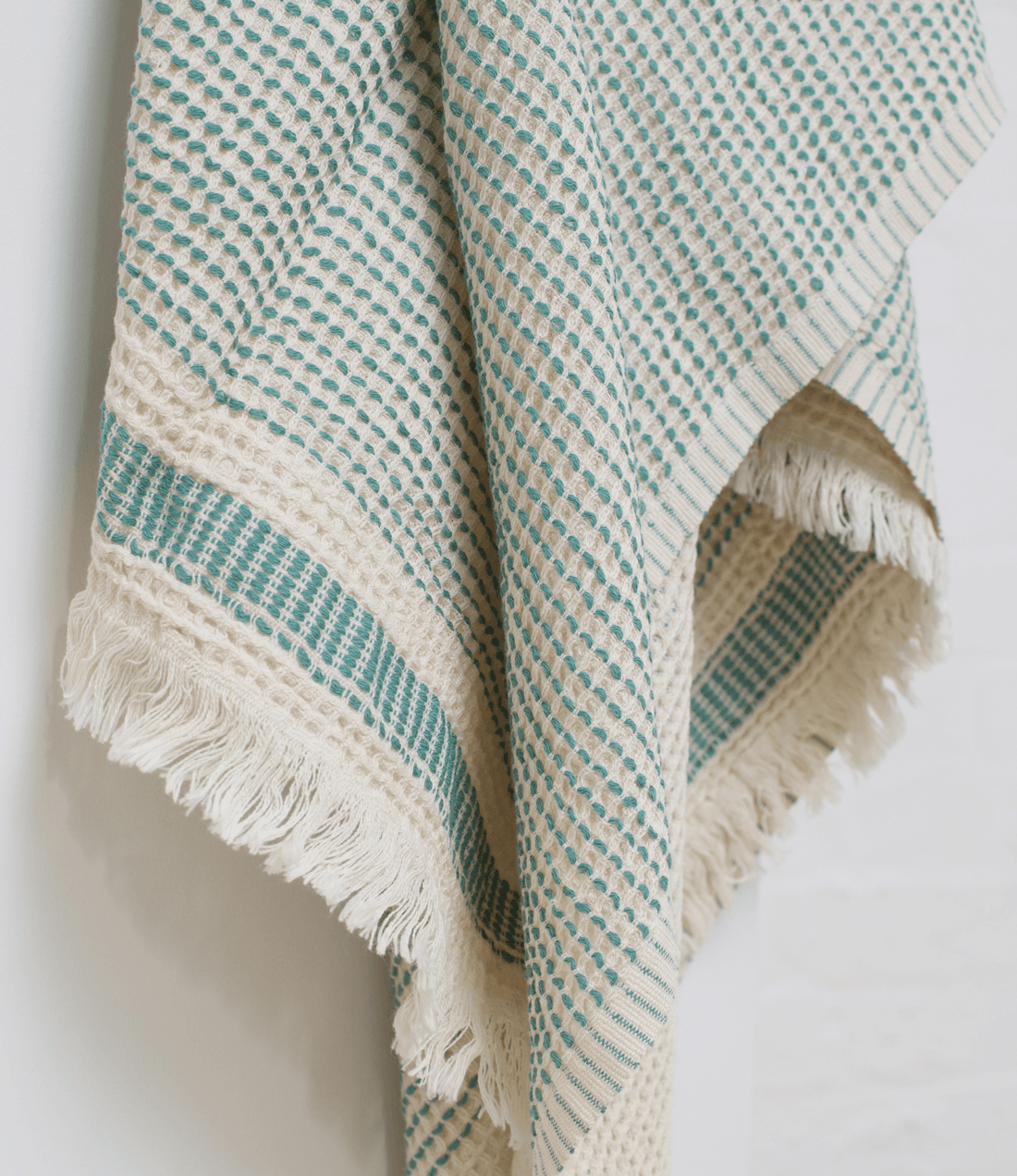 A dotted Turkish cotton "Kalkan" beach towel in sage green