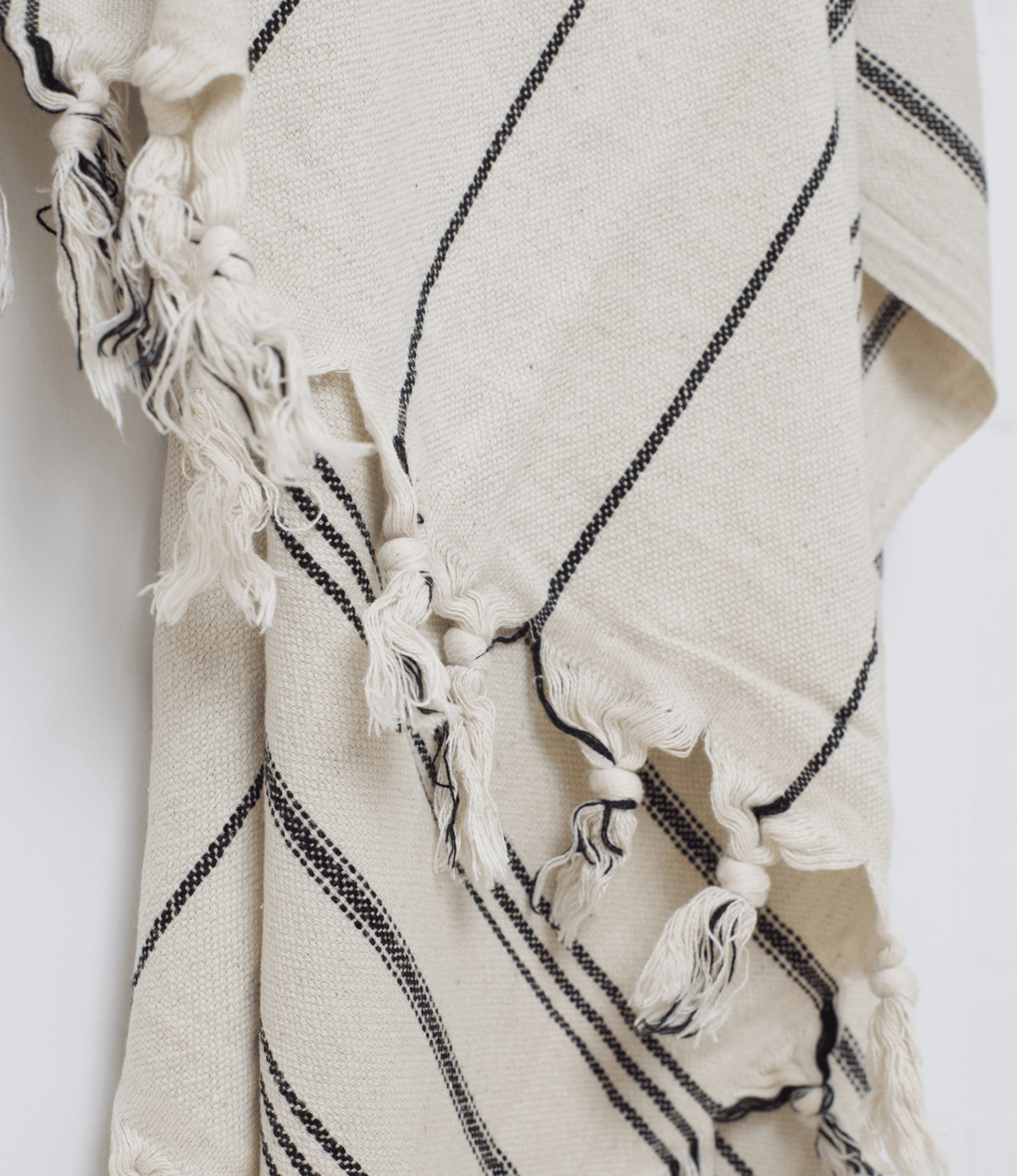 A premium linen "Kekova" Turkish towel in Beige with black stripes