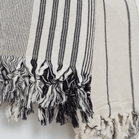 Two premium linen "Kekova" Turkish towels. One in Beige with black stripes and Black & Beige stripe